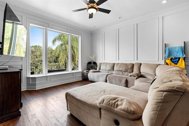 living room featuring ceiling fan, crown molding, and dark hardwood / wood-style flooring