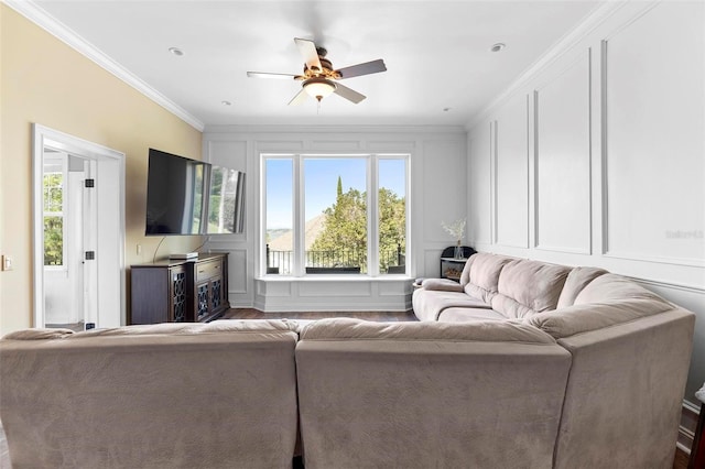 living room featuring hardwood / wood-style floors, ceiling fan, and ornamental molding