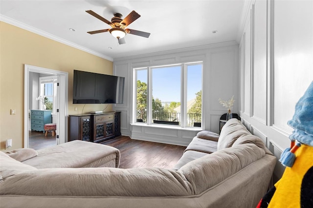 living room featuring ceiling fan, crown molding, and dark wood-type flooring