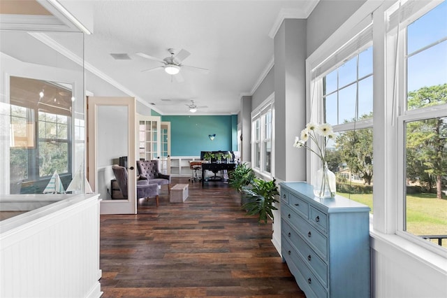 sunroom / solarium featuring ceiling fan