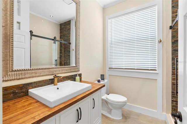 bathroom with toilet, vanity, crown molding, and an enclosed shower