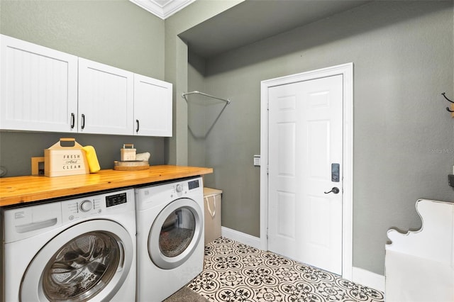 washroom with cabinets, crown molding, washer and clothes dryer, and light tile patterned floors