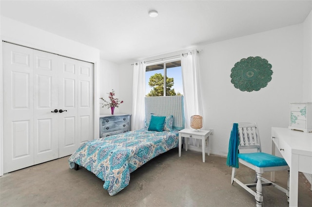 bedroom featuring a closet and concrete floors