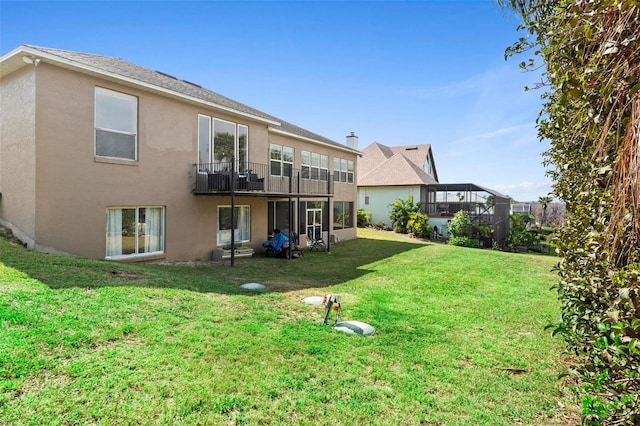 rear view of house featuring a yard