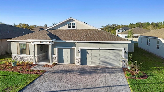 view of front of house featuring a garage and a front lawn