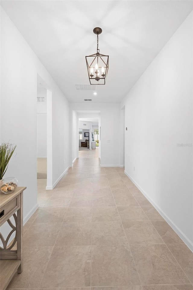 corridor featuring an inviting chandelier