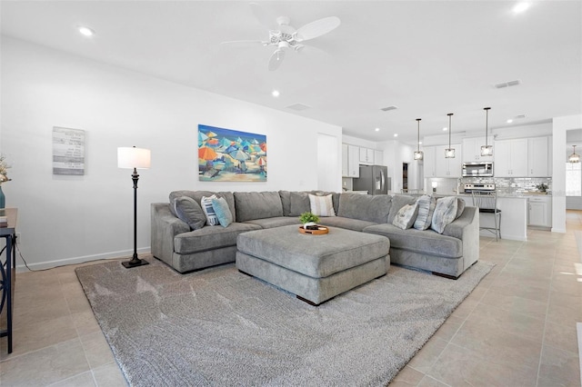 tiled living room featuring ceiling fan