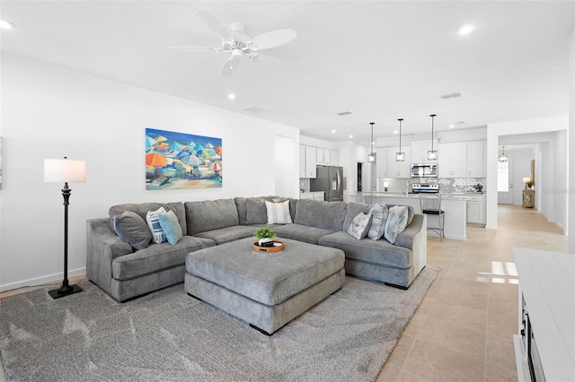 living room featuring light tile patterned flooring and ceiling fan