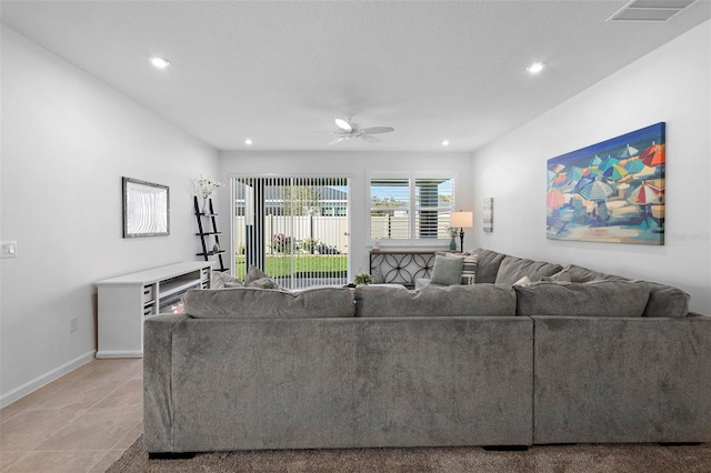 tiled living room with ceiling fan