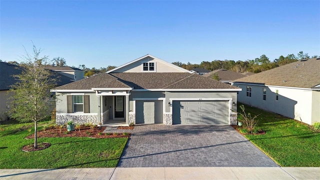 view of front of house featuring a front yard and a garage