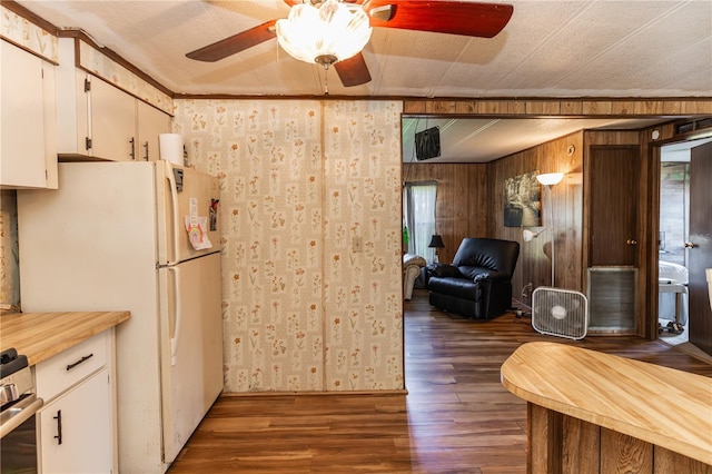 kitchen with dark wood-style flooring, white cabinetry, light countertops, freestanding refrigerator, and range