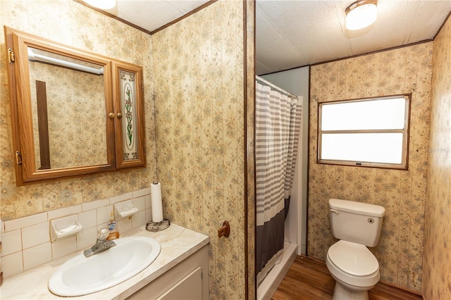 full bathroom featuring toilet, vanity, a shower stall, wood finished floors, and wallpapered walls