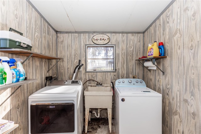 laundry room featuring laundry area, a sink, and washer and clothes dryer