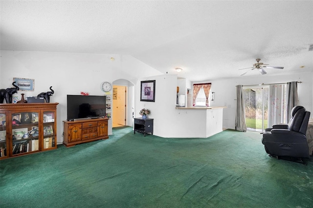 living room with arched walkways, a textured ceiling, carpet floors, visible vents, and vaulted ceiling