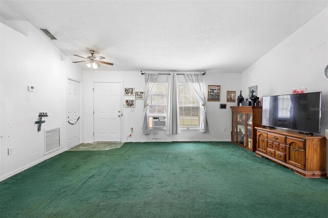 unfurnished living room with dark colored carpet, visible vents, and a textured ceiling