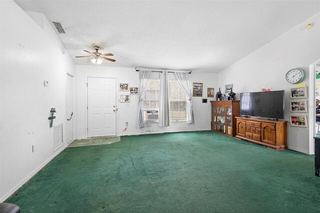 unfurnished living room with carpet, visible vents, a textured ceiling, and baseboards