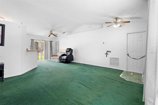 interior space with a textured ceiling, ceiling fan, carpet floors, visible vents, and vaulted ceiling