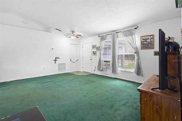 carpeted living area with visible vents, ceiling fan, a textured ceiling, cooling unit, and baseboards