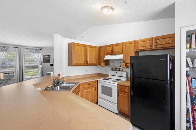 kitchen with freestanding refrigerator, light countertops, a sink, and white range with electric cooktop