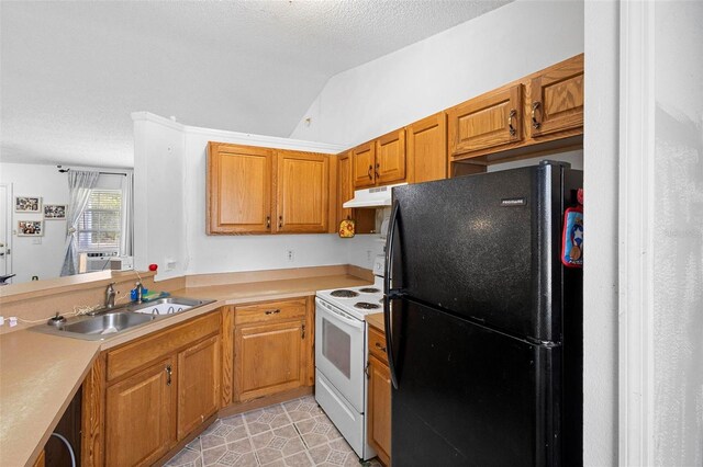 kitchen with brown cabinets, white range with electric cooktop, light countertops, freestanding refrigerator, and a sink