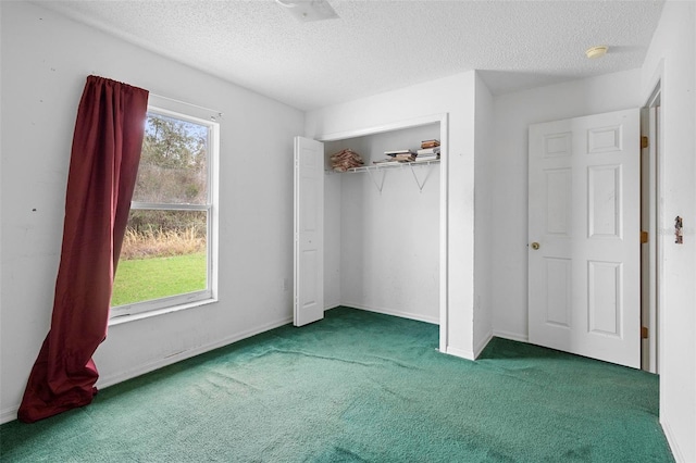 unfurnished bedroom with a textured ceiling, a closet, and carpet flooring