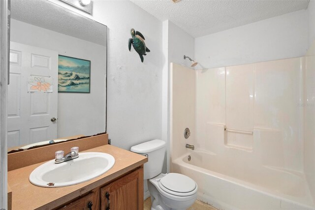 bathroom featuring a textured ceiling, toilet, shower / bath combination, and vanity