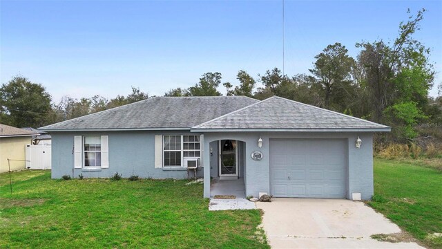 ranch-style house featuring driveway, a garage, and a front yard