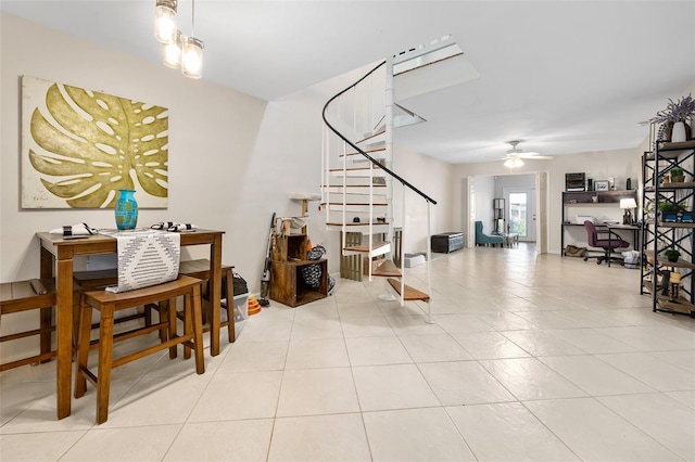 tiled dining space featuring ceiling fan