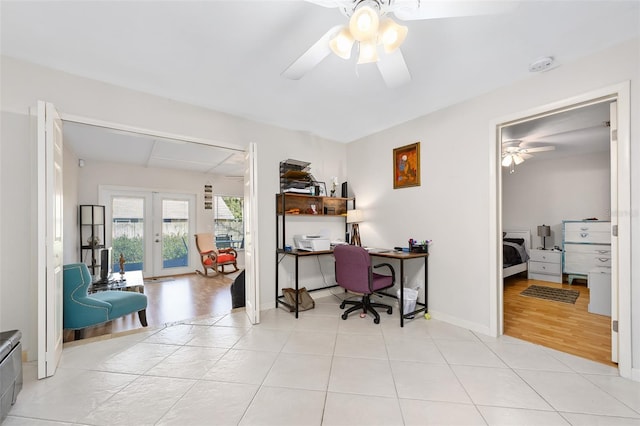 tiled office with ceiling fan and french doors