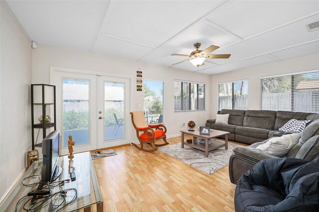 living room with hardwood / wood-style floors, a healthy amount of sunlight, and french doors