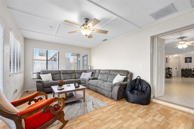 living room with light hardwood / wood-style floors and ceiling fan