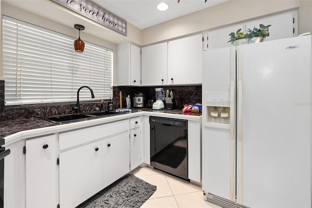 kitchen with white refrigerator with ice dispenser, sink, black dishwasher, light tile patterned floors, and white cabinets