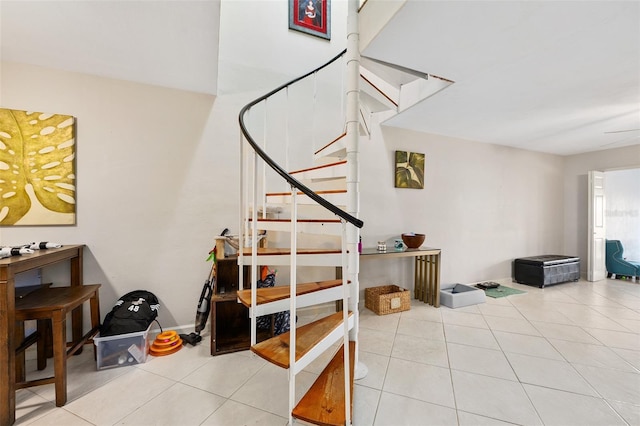 stairway with tile patterned floors