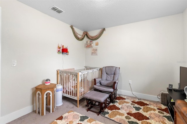 carpeted bedroom featuring a textured ceiling