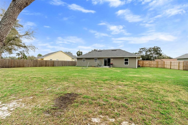 back of house with a yard