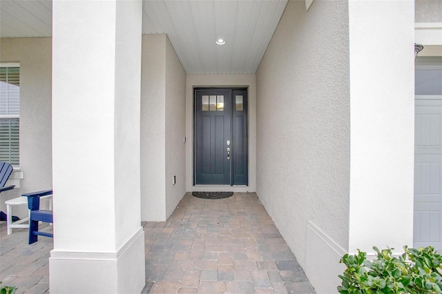 view of exterior entry with stucco siding