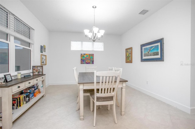 dining area featuring baseboards, visible vents, and a chandelier