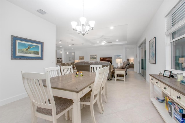 dining room with recessed lighting, baseboards, visible vents, a raised ceiling, and ceiling fan with notable chandelier