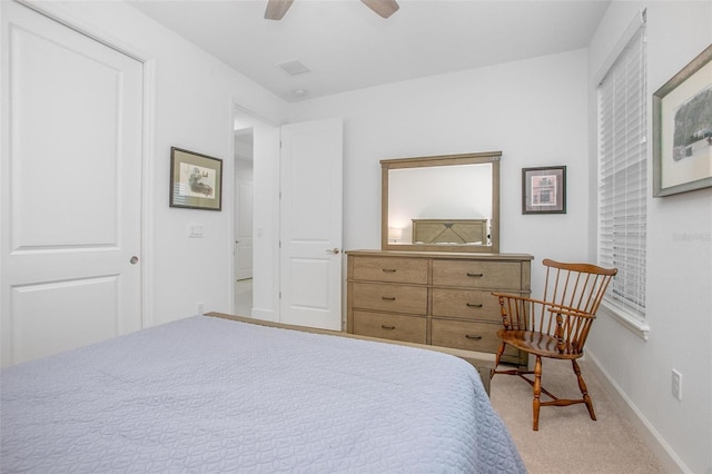 carpeted bedroom featuring visible vents, ceiling fan, and baseboards