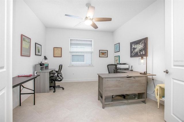 office area with light tile patterned floors, ceiling fan, and baseboards