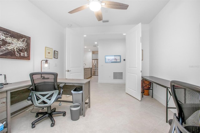 home office with recessed lighting, visible vents, a ceiling fan, a sink, and baseboards