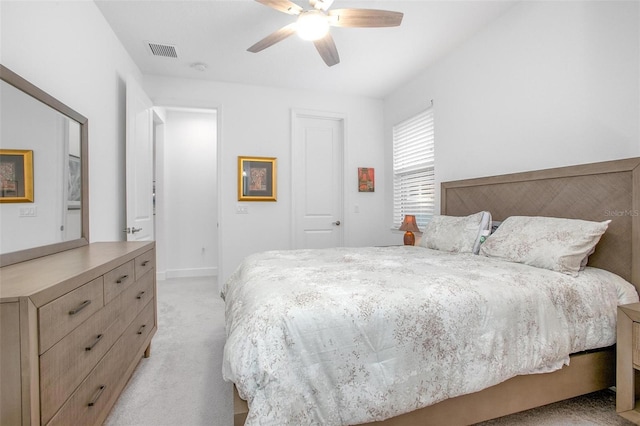 bedroom with a closet, visible vents, a ceiling fan, light carpet, and baseboards