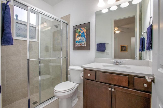 full bathroom featuring toilet, a stall shower, ceiling fan, and vanity