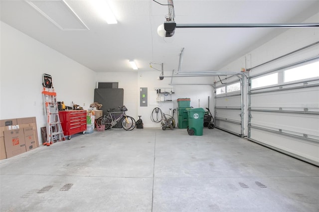 garage featuring electric panel and a garage door opener