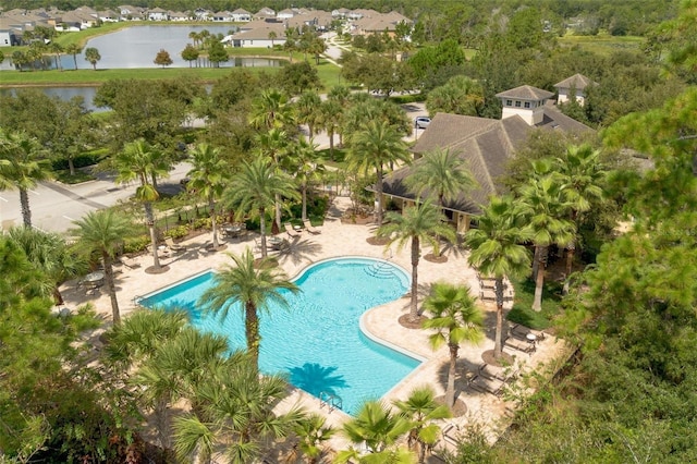 community pool with a water view and a patio area