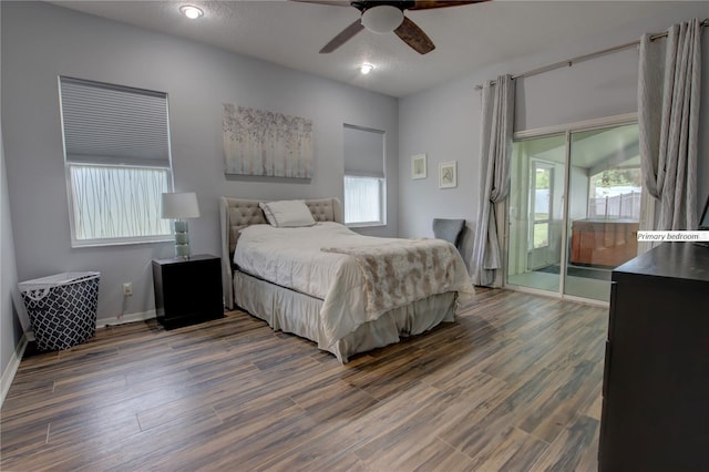 bedroom with ceiling fan, access to outside, dark wood-style flooring, and baseboards