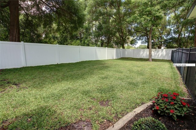 view of yard with a fenced backyard