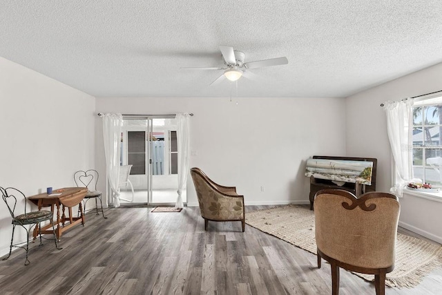 living area with french doors, dark wood-type flooring, and a textured ceiling