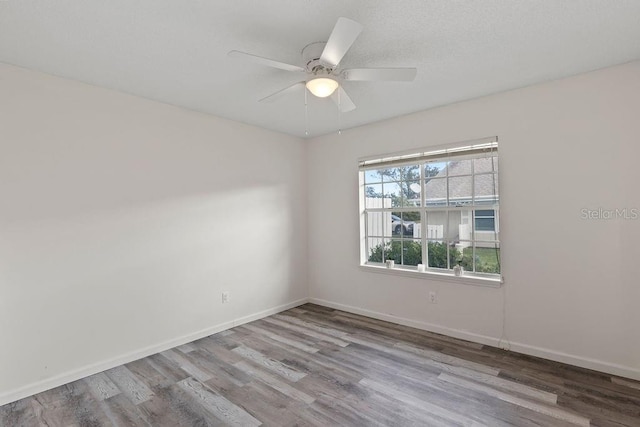 spare room with light hardwood / wood-style flooring and ceiling fan