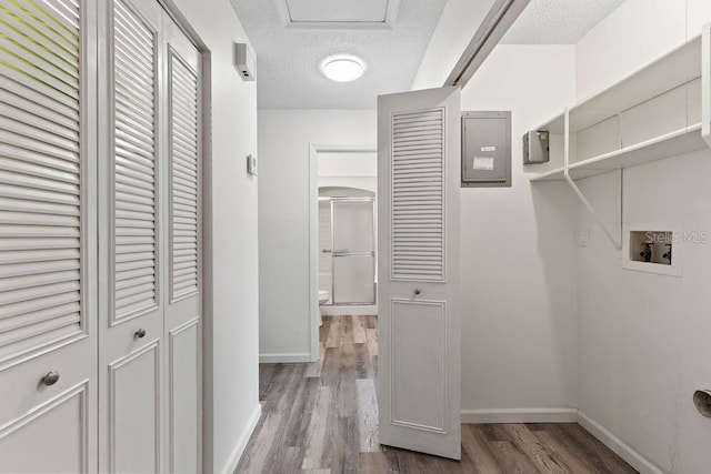 interior space with washer hookup, light wood-type flooring, and a textured ceiling